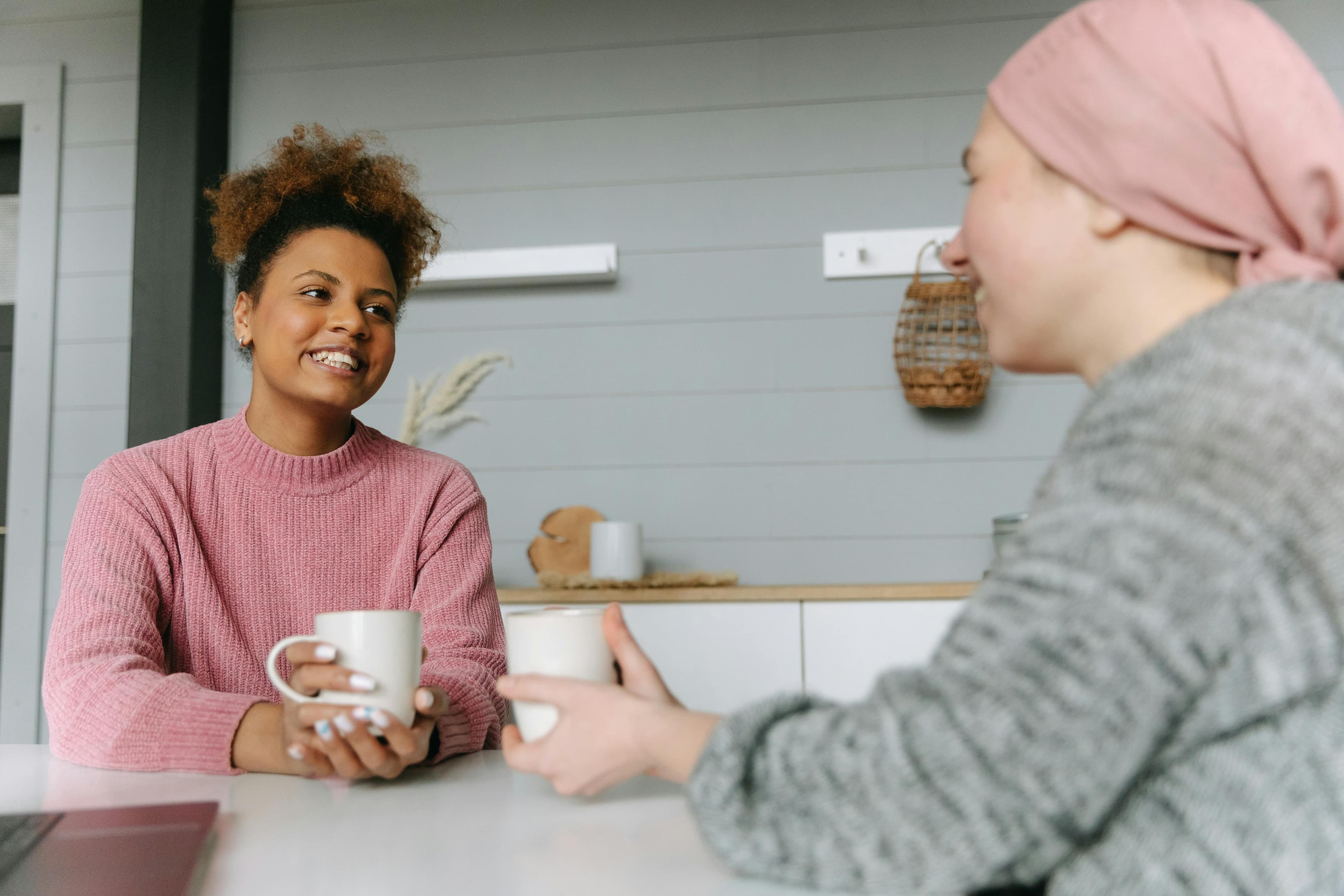 Two women having a conversation over coffee